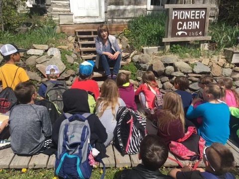 Historian Ellen Baumler educates school group on history of Pioneer Cabin"